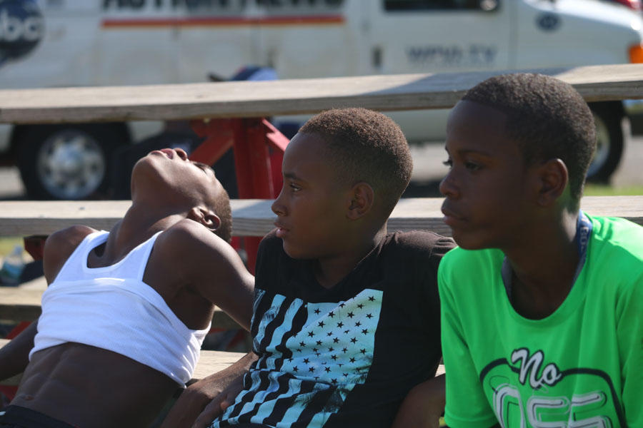 Jahmarr Gardner, right, and Naji Reid Lawrence Lewis look on during the softball game in support of their friend Alex, the pitcher on Strawberry Mansion’s team./Kaitlyn Moore