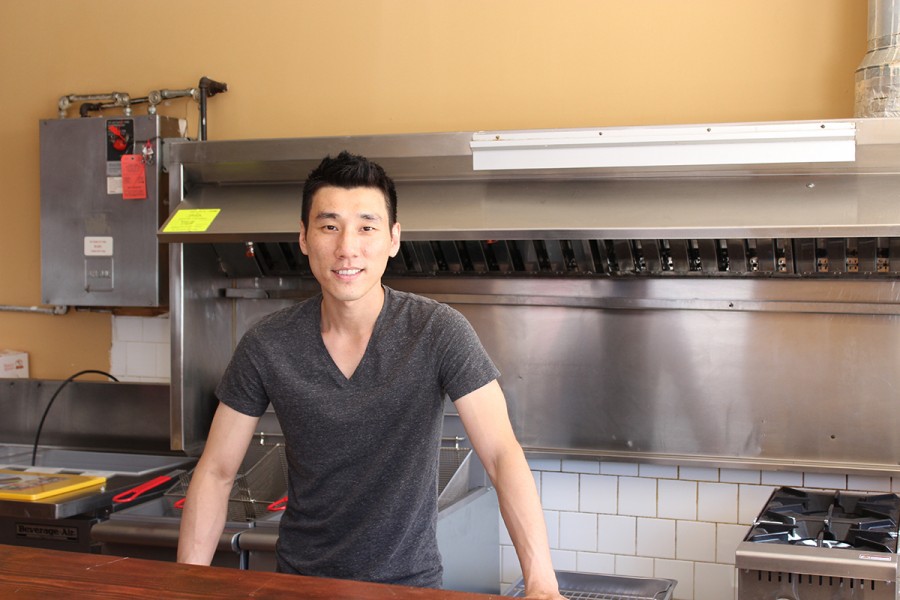 Andy Choi stands behind the counter of his new restaurant.