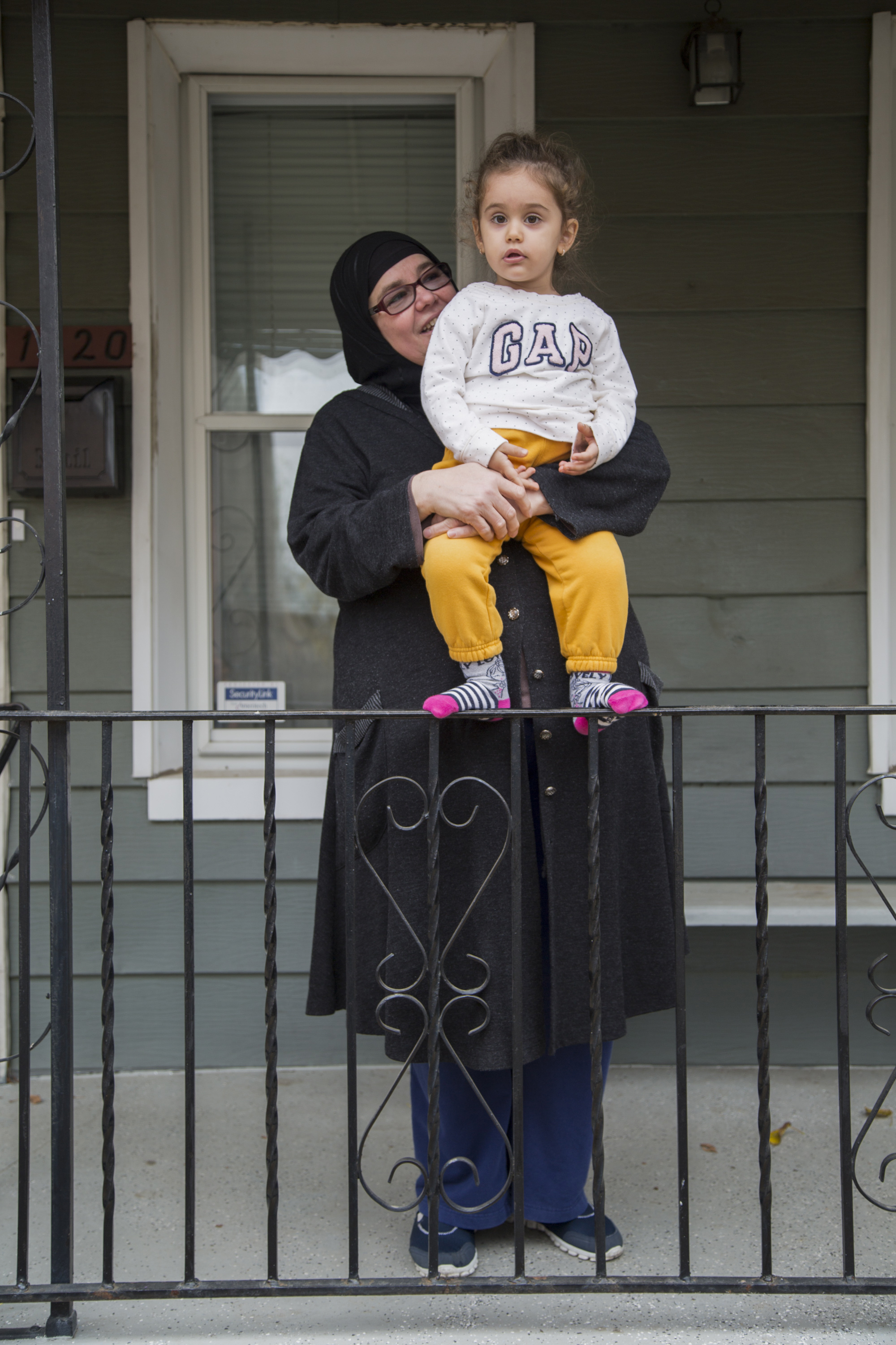Sirma Celep, left, holds her granddaughter, Armina, on the front porch in November 2015. The duo was photographed for the Philly Block Project in November 2015, a collaboration between the Philadelphia Photo Arts Center and Hank Willis Thomas. Photo by Wyatt Gallery/Hank Willis Thomas Studio. 