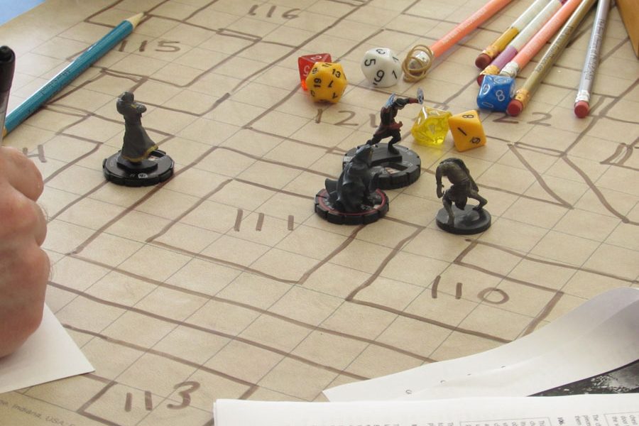 Players move their characters into position after rolling the set of die to determine the effectiveness of their attacks. In this setup, a warrior, thief and wizard are fighting a zombified ape./Ruthann Alexander