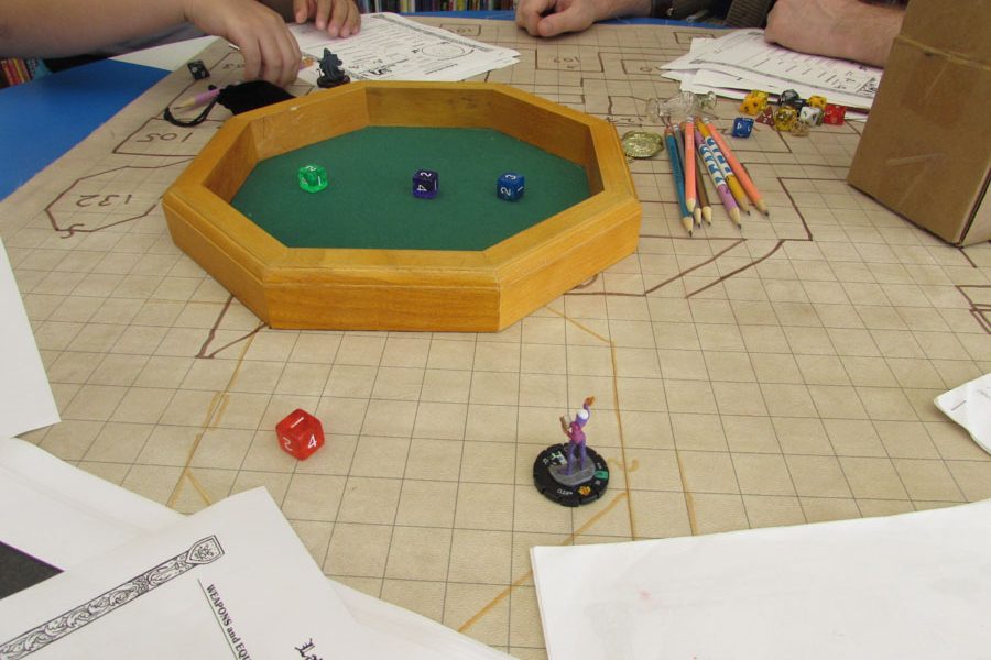 The Dungeons and Dragons board is set up and cluttered with figurines, character sheets and other props for enhancing the game experience./Ruthann Alexander