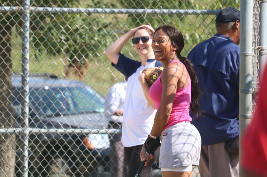 Strawberry Mansion teammate, Ebony Williams, right, shares a laugh with FBI catcher during the 10th annual Step Up to the Plate: Strike Out Violence softball game. /Kaitlyn Moore