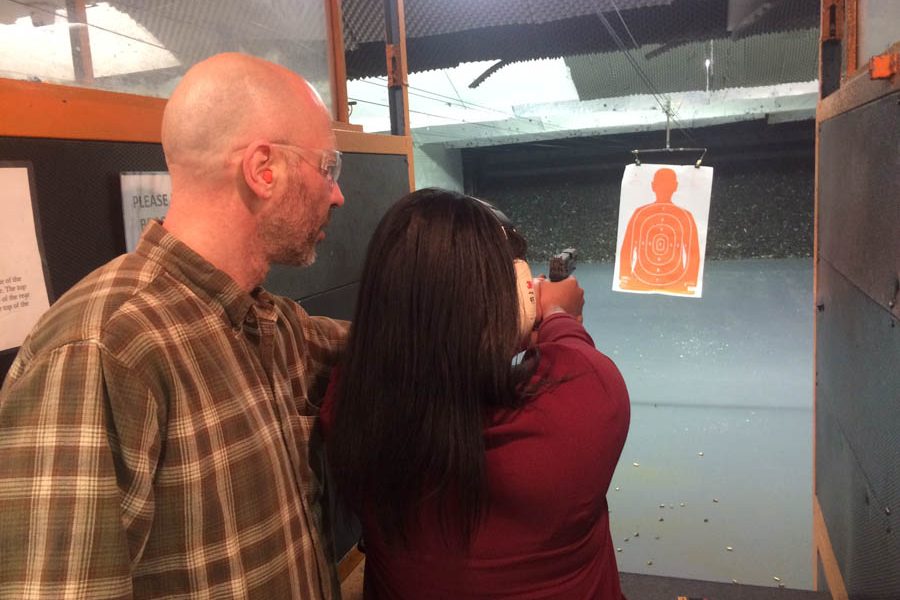 Yuri Zalzman instructs Jamila Lopez on how to use a handgun./Steve Bohnel