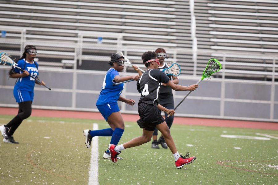 Nadirah “Slim” McCray cuts through opposing defenders on her way to scoring a goal. /Patrick Clark